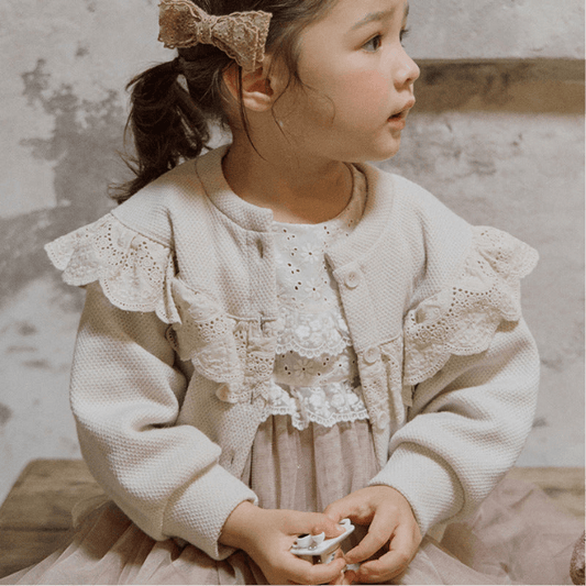 Toddler wearing a neutral baby cardigan