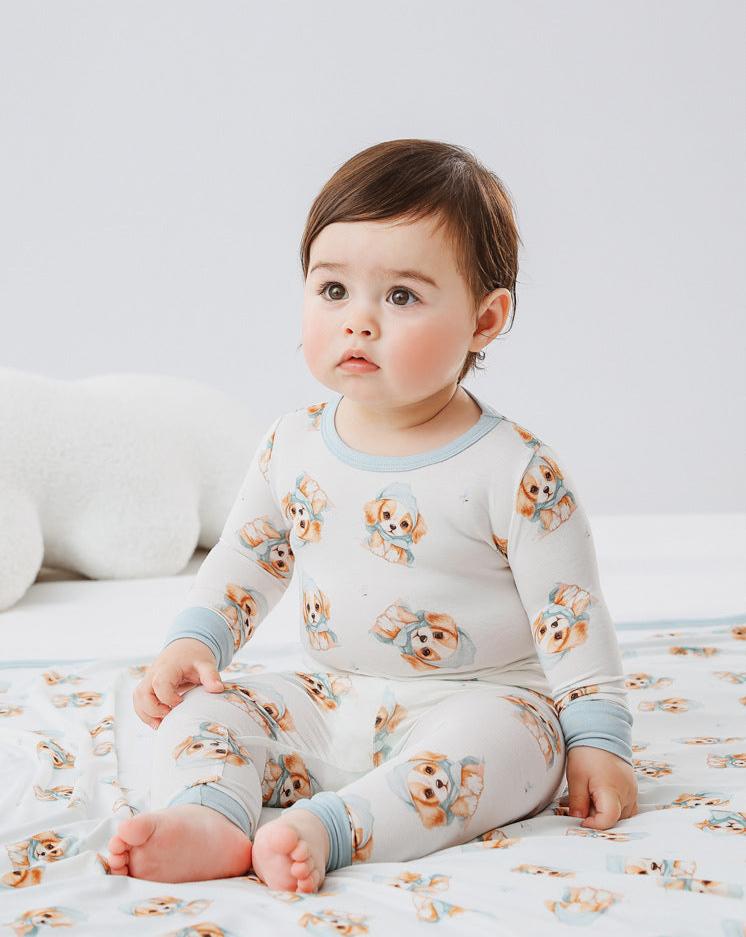 Adorable baby and toddler clothing by Isla + Bo featuring comfortable, breathable, and machine washable outfits. Includes bamboo sleepers, cotton knit sets, classic denim dresses, and more in a variety of styles and prints like floral, plaid, and animal designs.